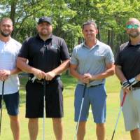 2 men in black with other two men